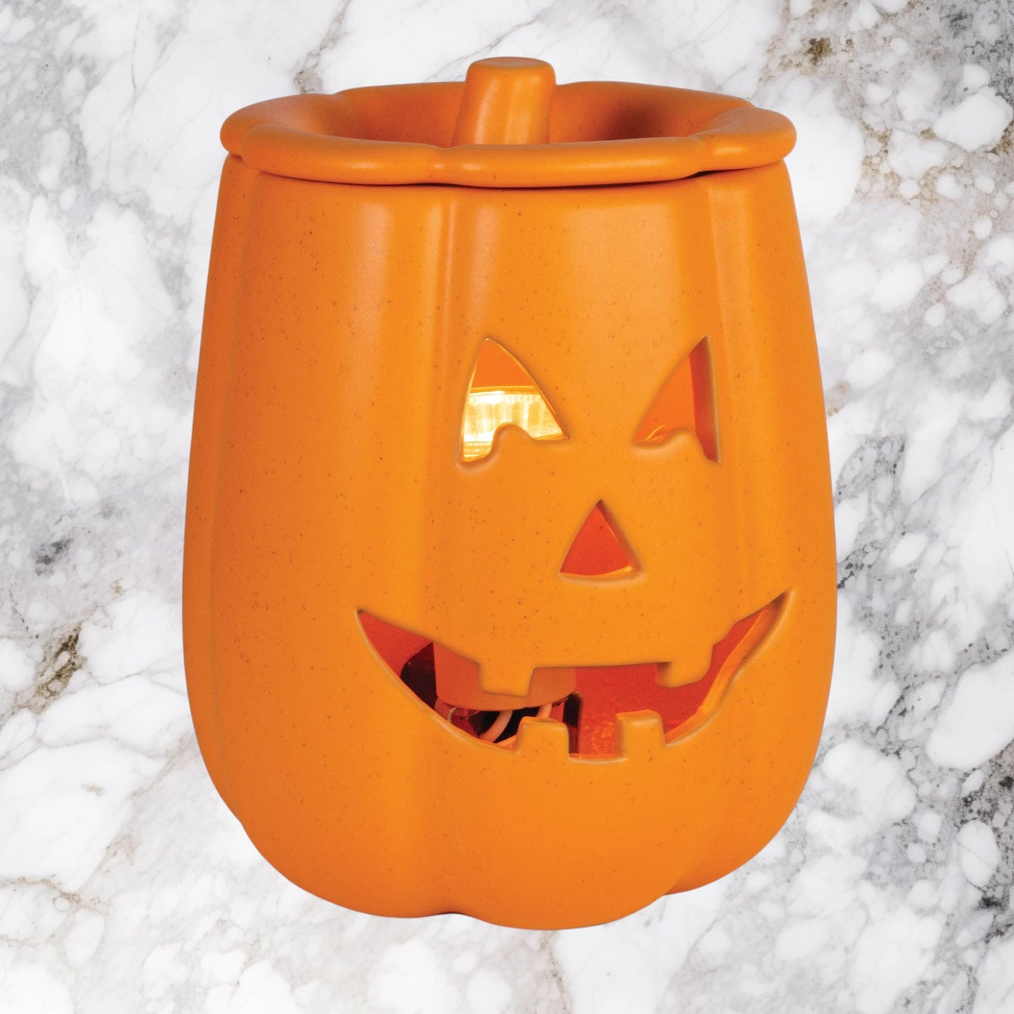 Doodlations Coffee Bar & Boutique orange ceramic Jack o' Lantern electric wax warmer with glowing interior light