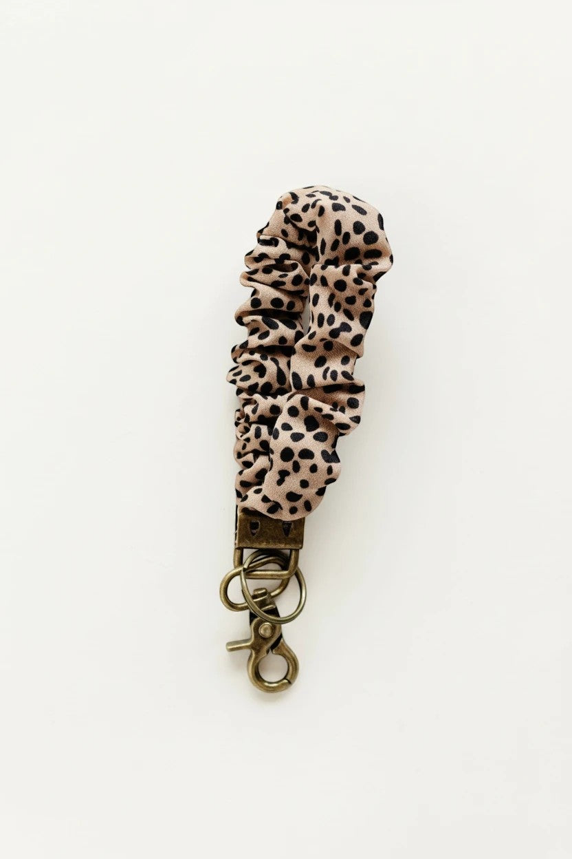 Doodlations Coffee Bar & Boutique terracotta apricot fabric jungle cat print scrunchie keychain with bronze hardware