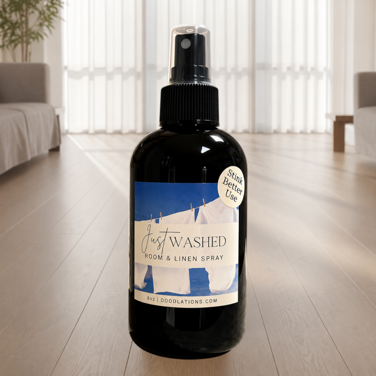 Doodlations Coffee Bar & Boutique Just Washed room and linen spray in a black bottle with a fresh laundry label