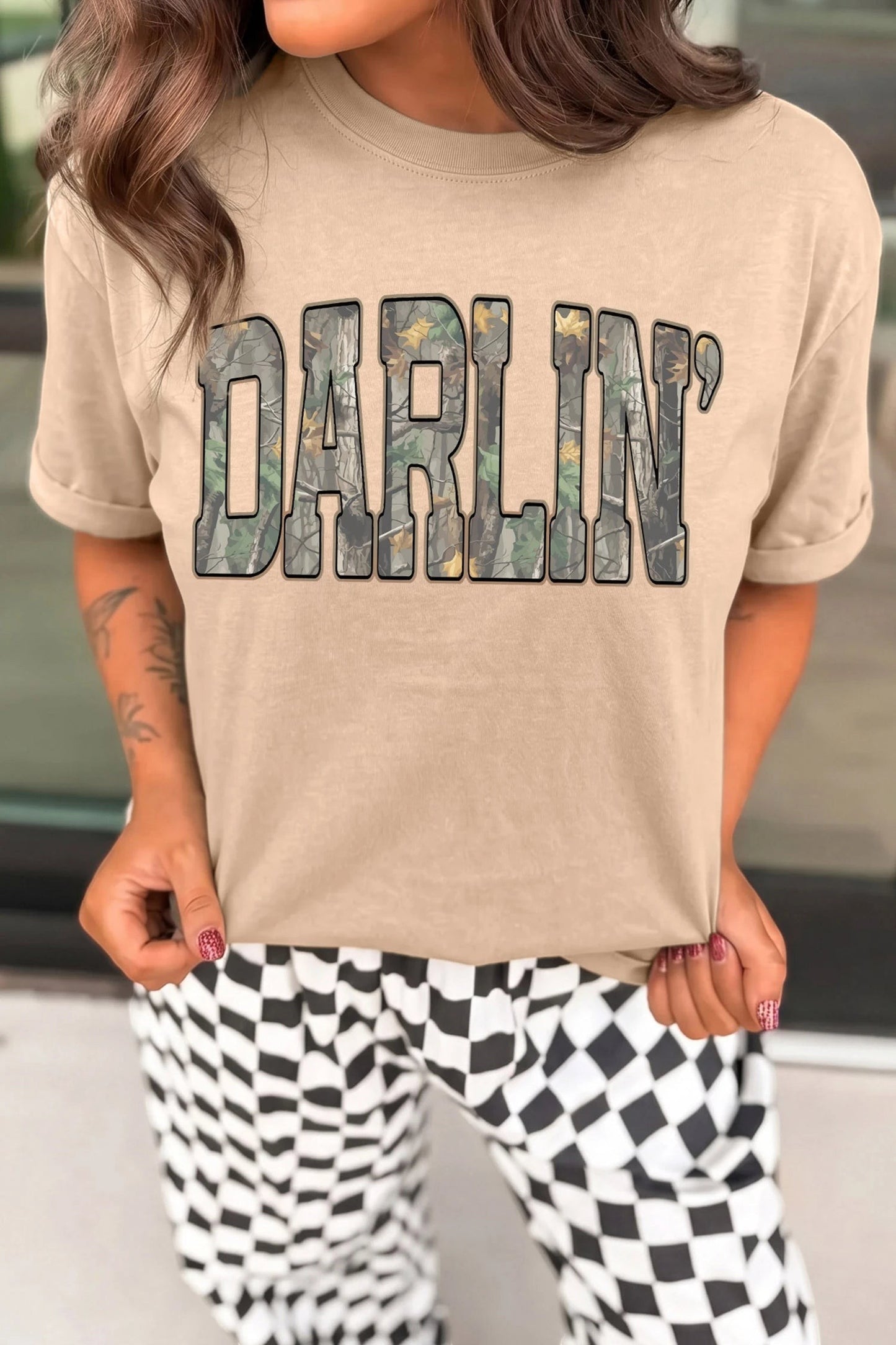 Doodlations Coffee Bar & Boutique khaki crewneck t-shirt with DARLIN camo letter print worn by a woman