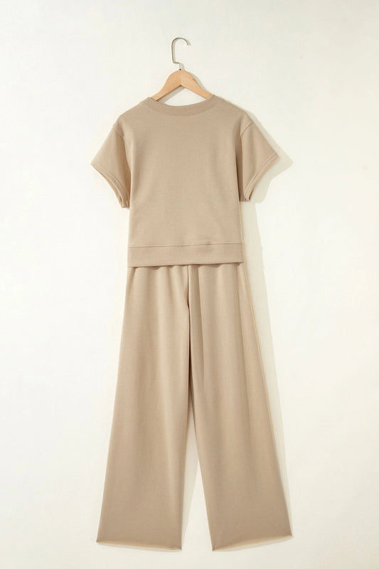 Doodlations Coffee Bar & Boutique khaki two-piece set with a short sleeve tee and wide-leg pants on a hanger.