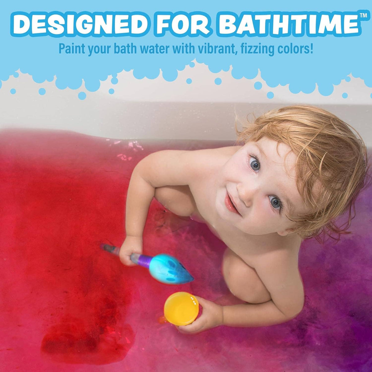 Doodlations Coffee Bar & Boutique Tub Works Bath Color Brush set being used by a toddler in vibrant red bath water