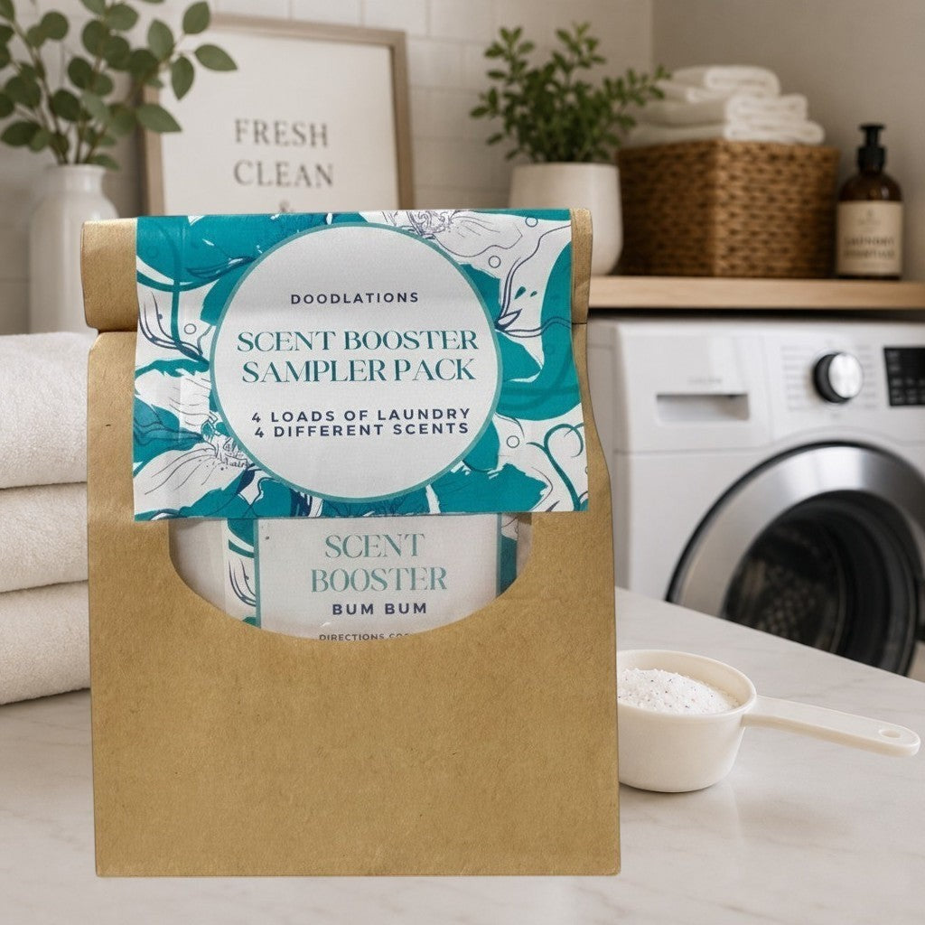 Doodlations Coffee Bar & Boutique laundry scent booster sampler pack in a brown paper bag with teal floral label.