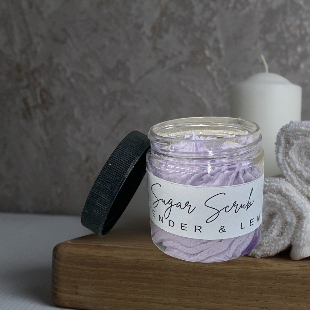 Doodlations Coffee Bar & Boutique Lavender & Lemon Sugar Scrub in a clear jar with a black lid. Whipped purple scrub.