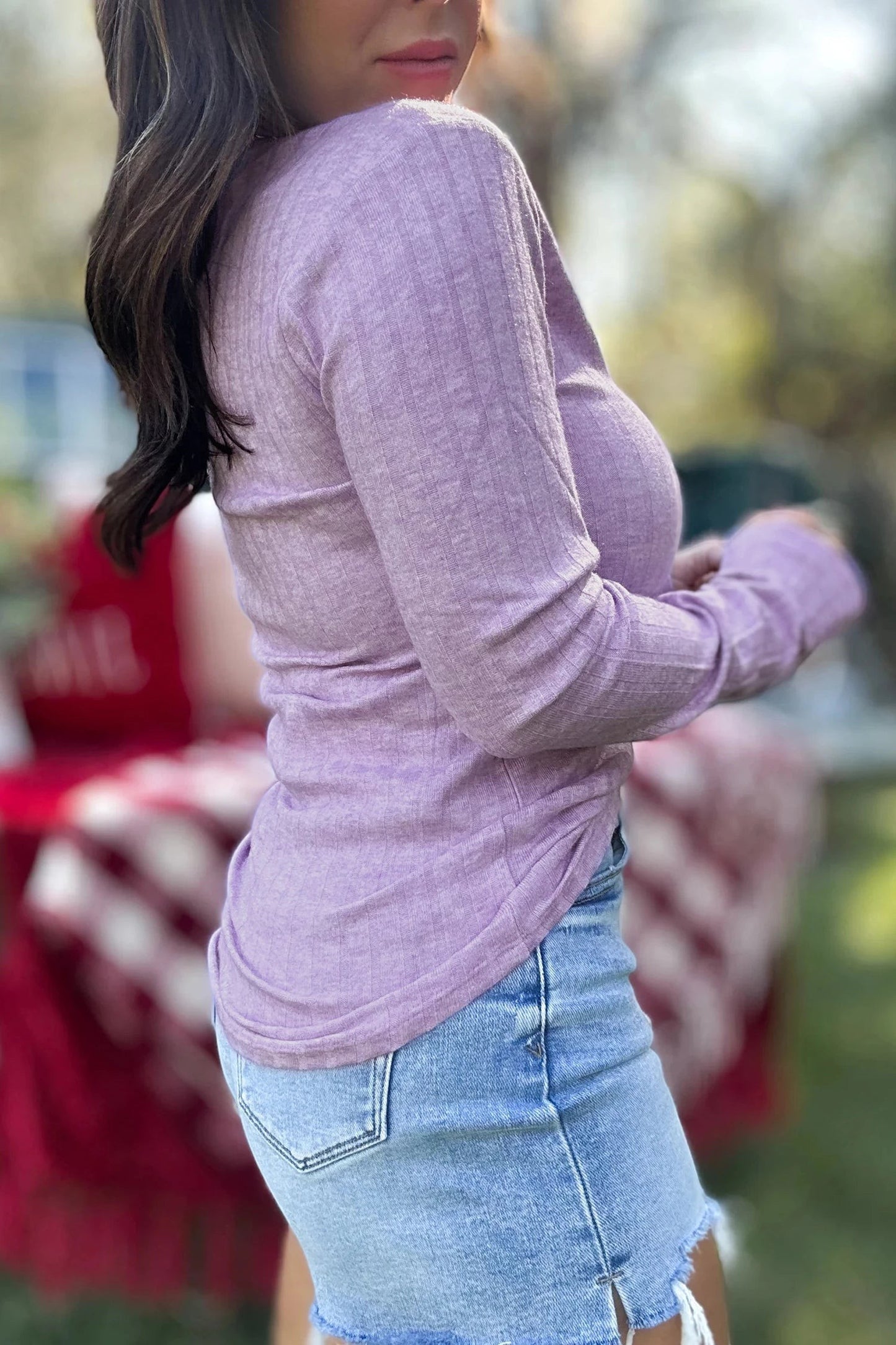 Doodlations Coffee Bar & Boutique lavender ribbed long sleeve top worn by a woman with denim shorts outdoors