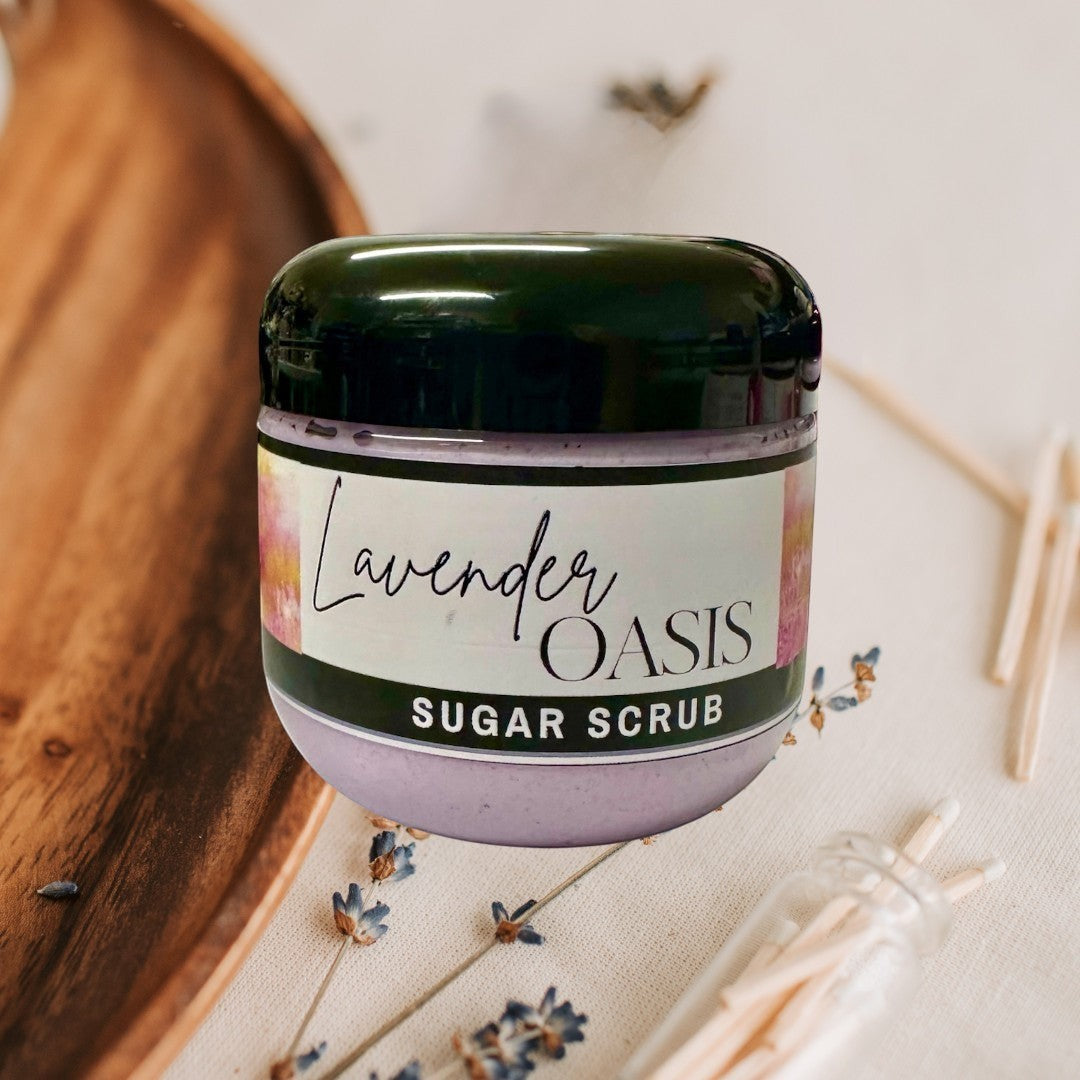 Doodlations Coffee Bar & Boutique Lavender Oasis Sugar Scrub in a clear jar with a black lid. The scrub is lavender colored.