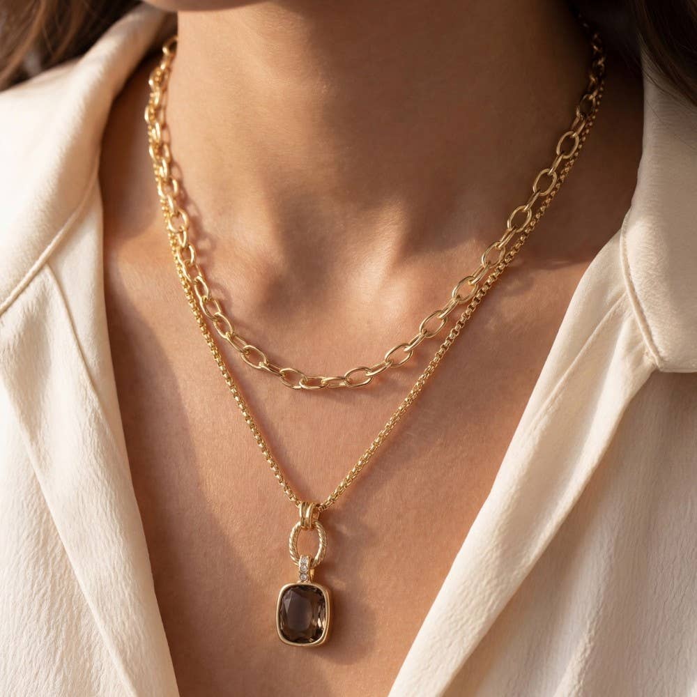 Doodlations Coffee Bar & Boutique layered gold-tone necklace featuring a chunky link chain and smoky gemstone pendant.