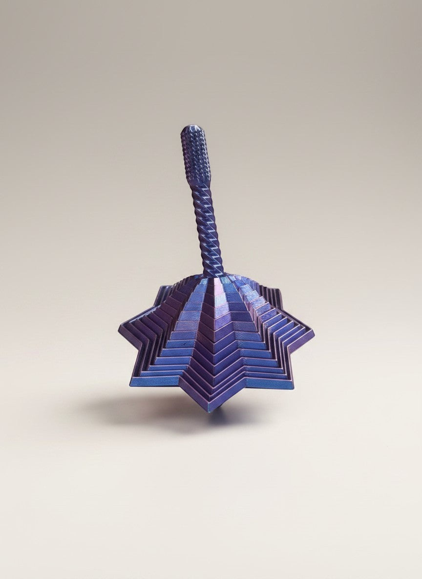 Doodlations Coffee Bar & Boutique layered star fidget toy in iridescent blue with textured handle.