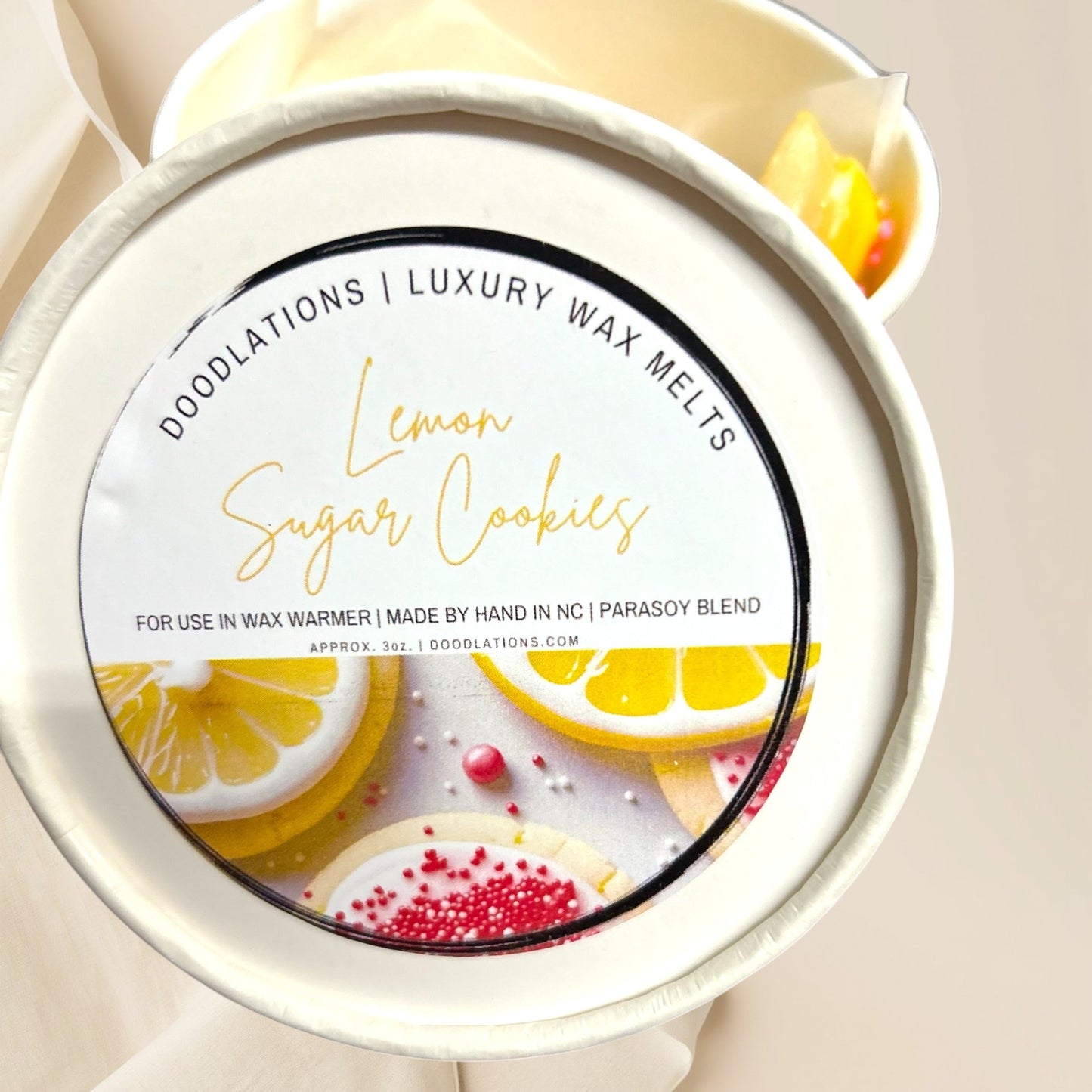 Doodlations Coffee Bar & Boutique Lemon Sugar Cookie luxury wax melts with lemon slices and sugar cookies.