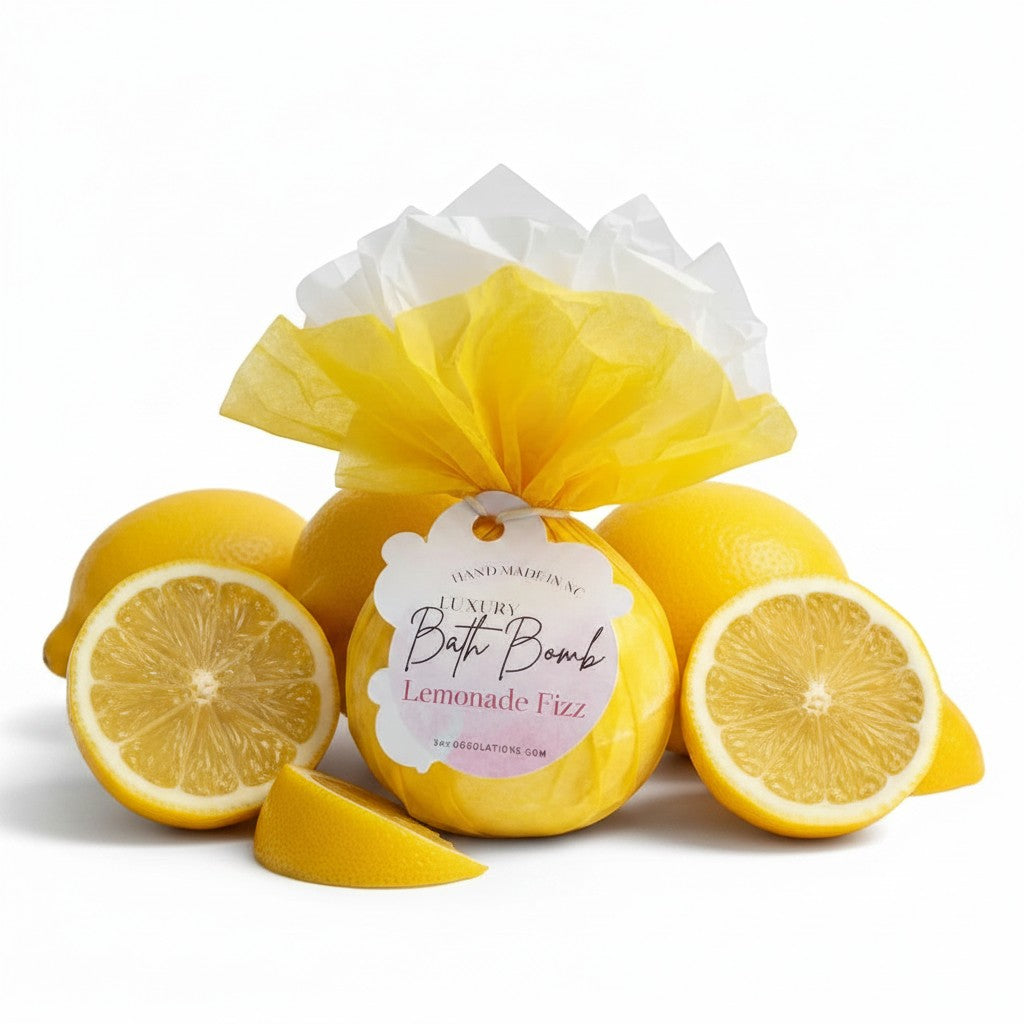 Doodlations Coffee Bar & Boutique Lemonade Fizz bath bomb wrapped in yellow tissue paper surrounded by fresh lemons.