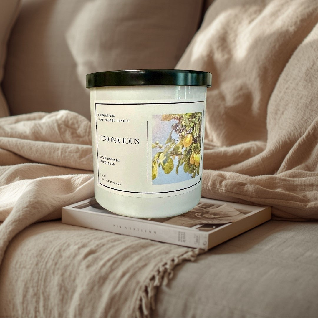 Doodlations Lemonicious hand-poured soy blend candle with a bright citrus scent, featuring lemons on a branch.