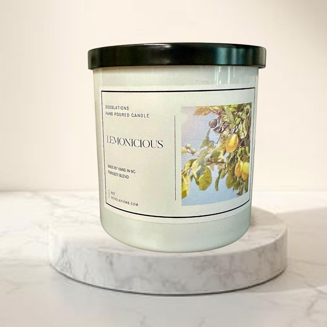 Doodlations Lemonicious hand-poured soy blend candle with a bright citrus scent, featuring lemons on a branch.