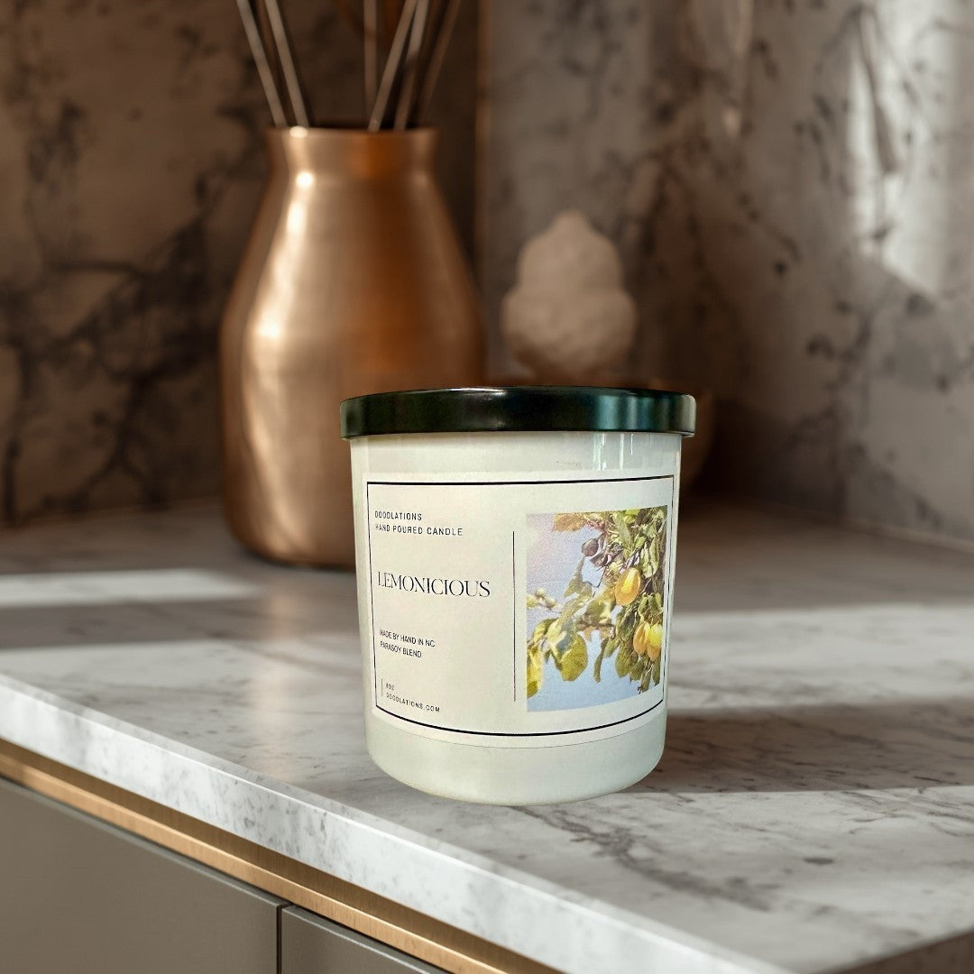 Doodlations Lemonicious hand-poured soy blend candle with a bright citrus scent, featuring a lemon tree illustration.