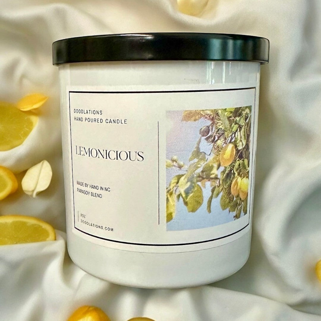 Doodlations Lemonicious hand-poured soy blend candle with a bright citrus scent, featuring lemons on a branch.