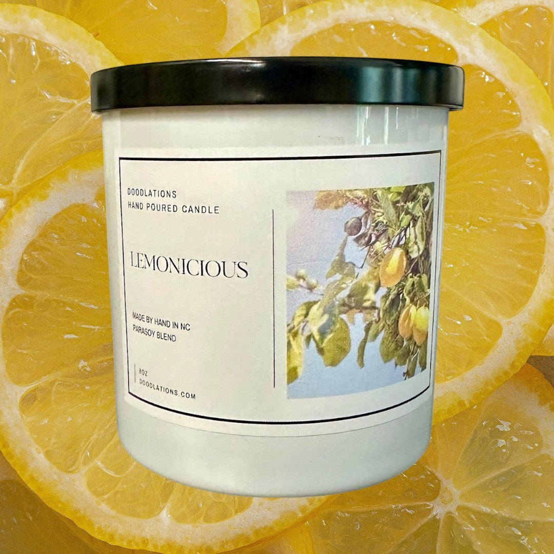 Doodlations Lemonicious hand-poured soy blend candle with a bright citrus scent, featuring lemons on a branch.