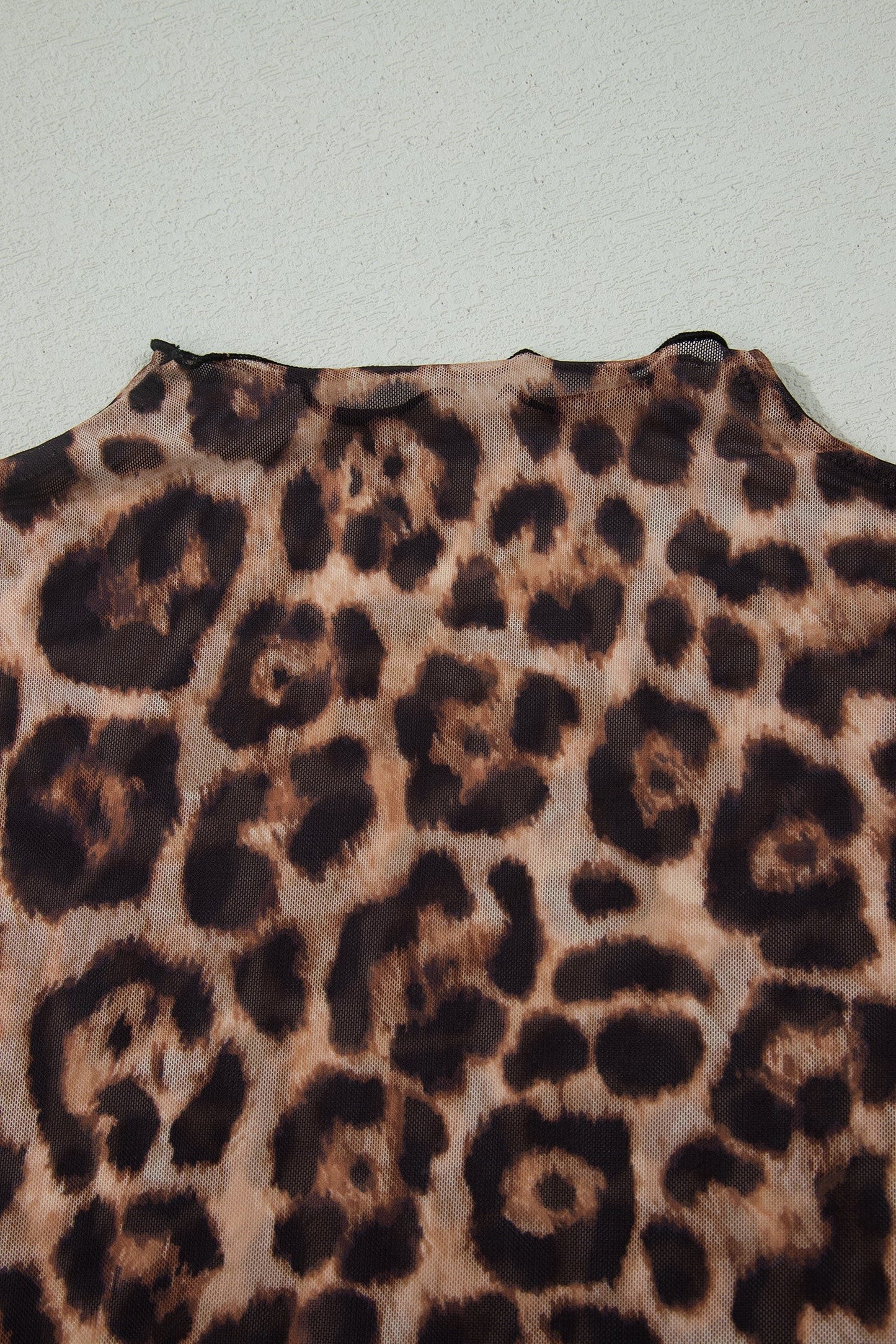 Doodlations Coffee Bar & Boutique leopard print mesh top with a close-up view of the semi-sheer fabric and neckline.