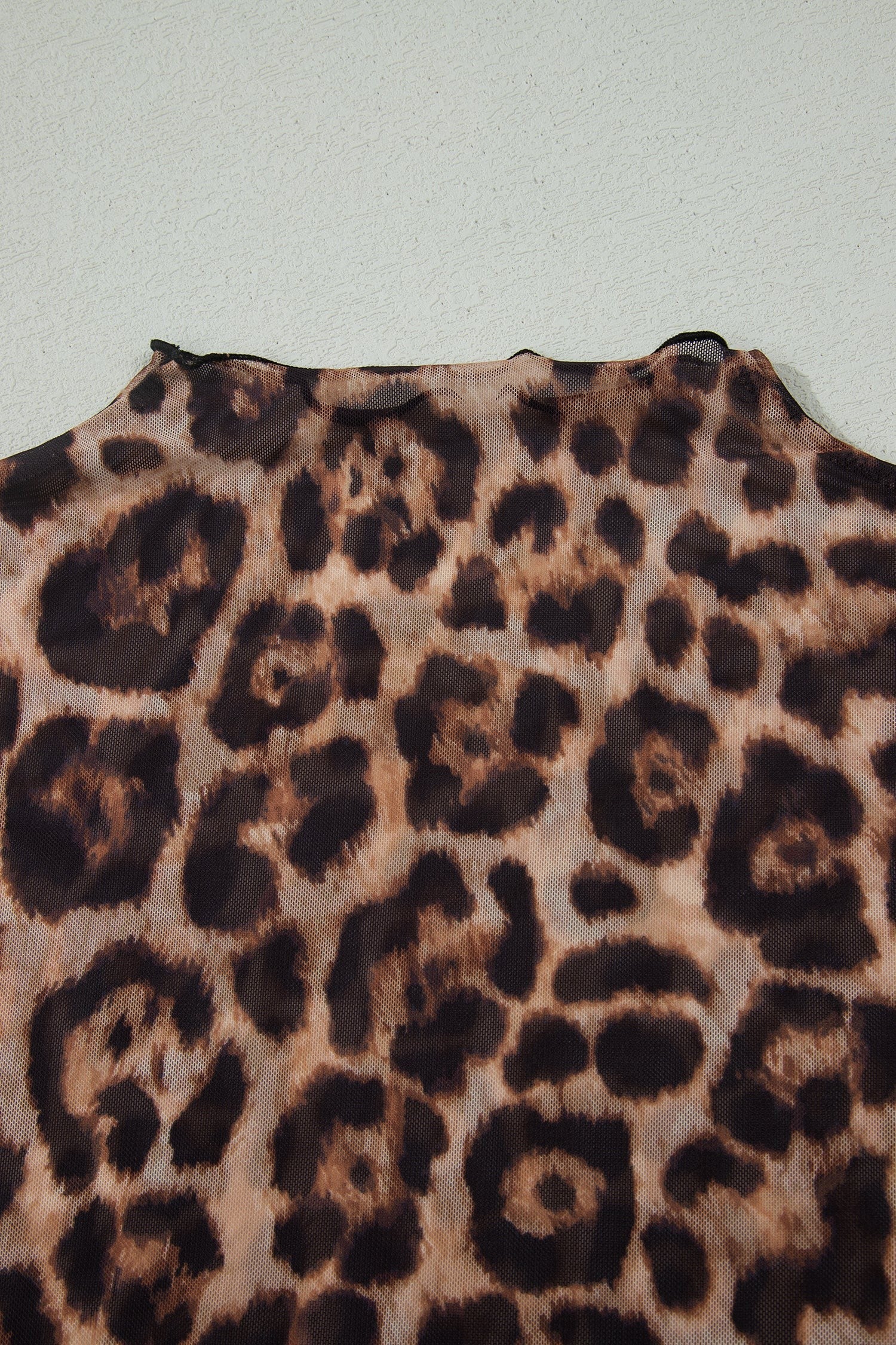 Doodlations Coffee Bar & Boutique leopard print mesh top with a close-up view of the semi-sheer fabric and neckline.