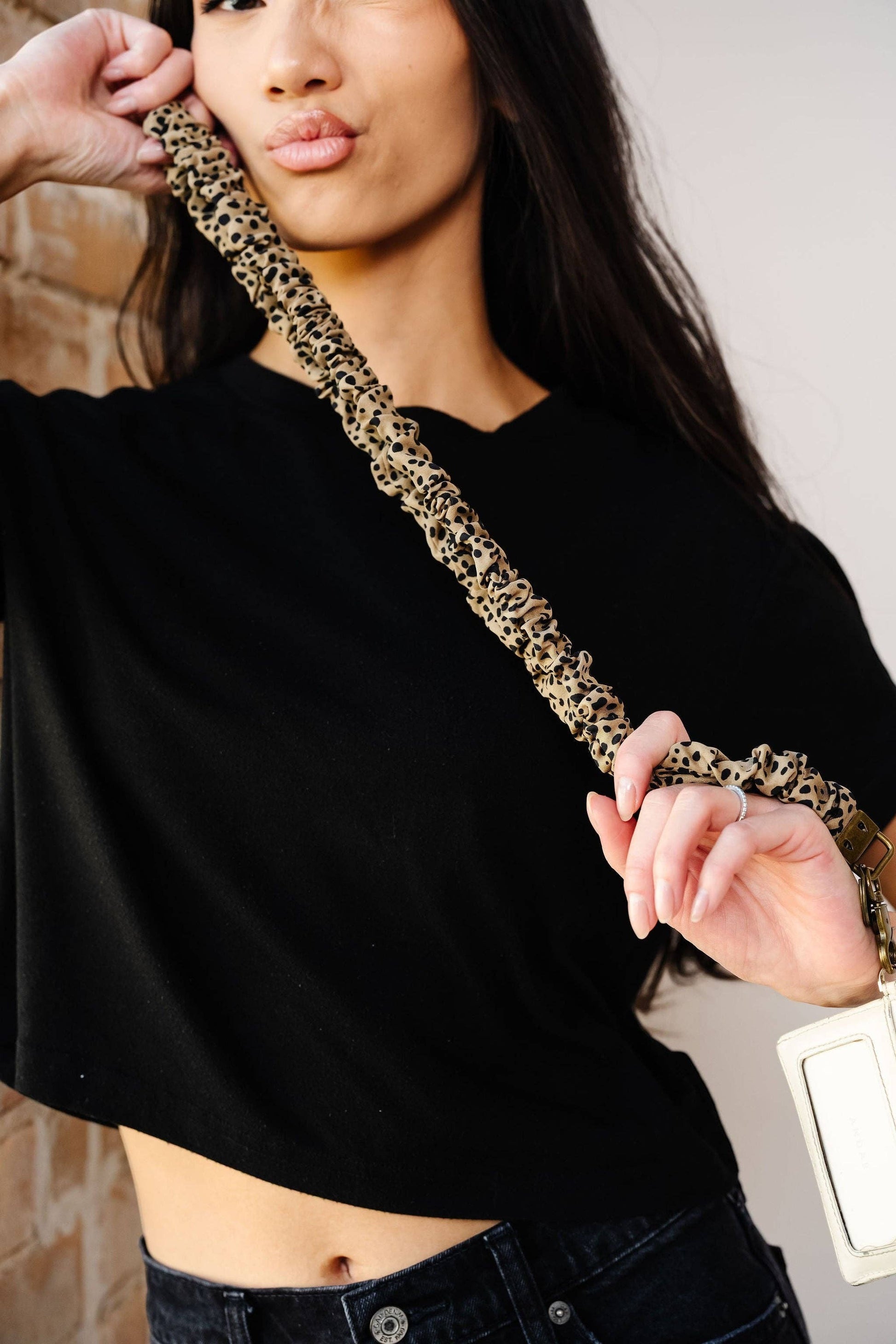 Doodlations Coffee Bar & Boutique leopard print scrunchie lanyard with antique brass hardware worn by a model
