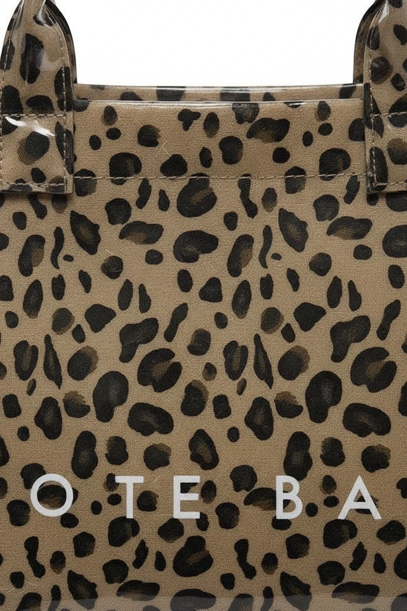 Doodlations Coffee Bar & Boutique leopard print tote bag with a glossy PVC finish and durable poly construction.