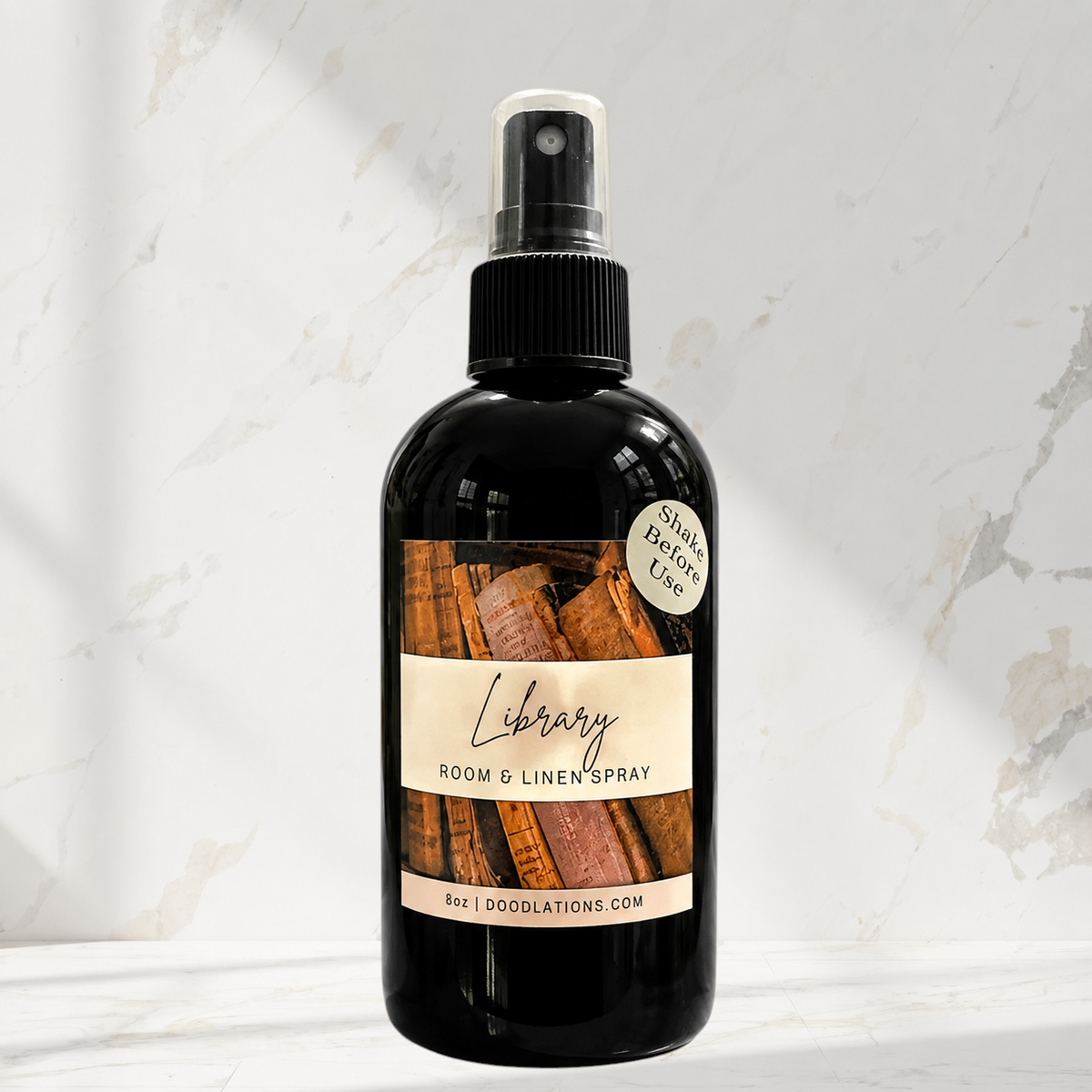 Doodlations Coffee Bar & Boutique Library room and linen spray in a black bottle with a vintage book label.