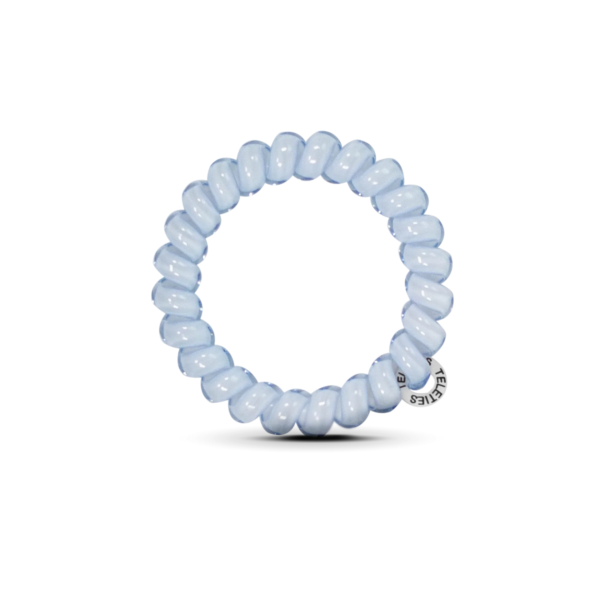 Doodlations Coffee Bar & Boutique light blue spiral hair tie with a small branded charm on a black background
