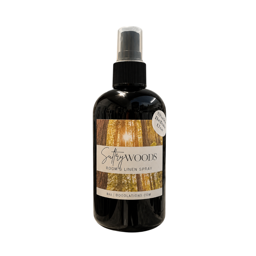 Doodlations Coffee Bar & Boutique 8oz room and linen spray in a black bottle with a forest-themed label