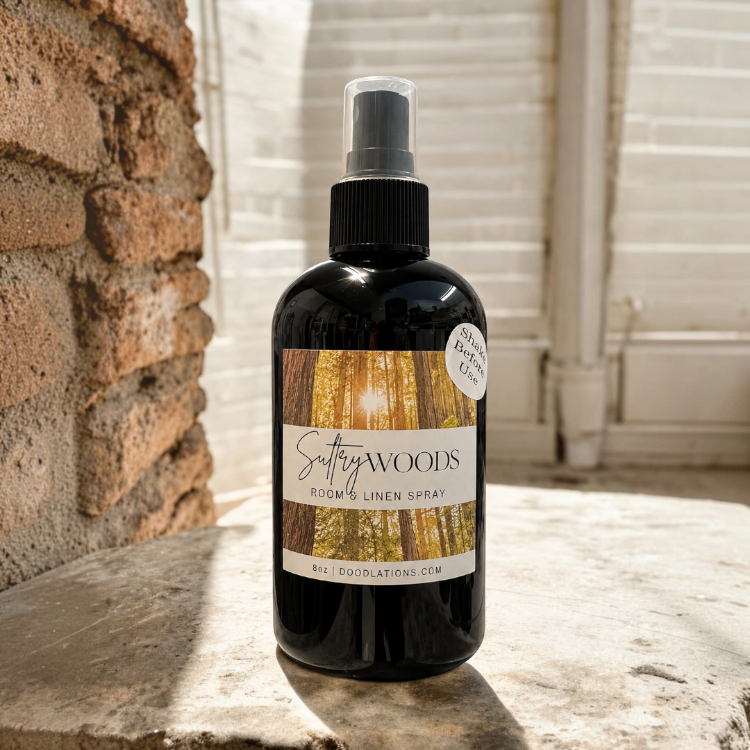 Doodlations Coffee Bar & Boutique Autumn Flannel room and linen spray in a black bottle on a stone surface