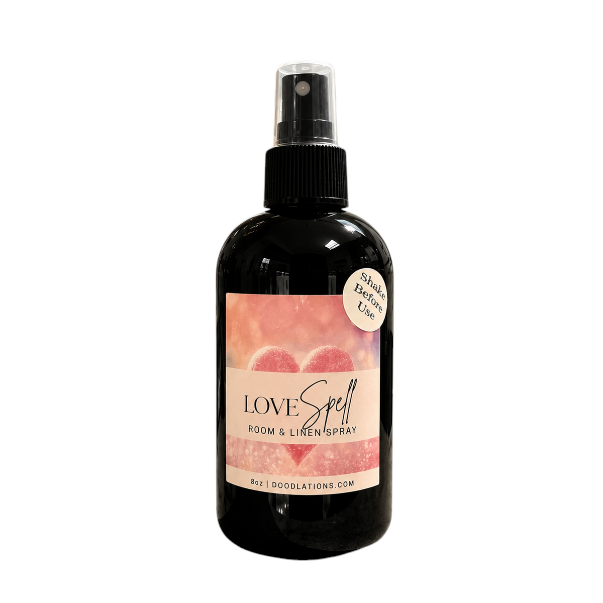 Doodlations Coffee Bar & Boutique Love Spell room and linen spray in a black bottle with a pink heart label