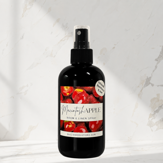 Doodlations Coffee Bar & Boutique Macintosh Apple room and linen spray in a black bottle against a marble background