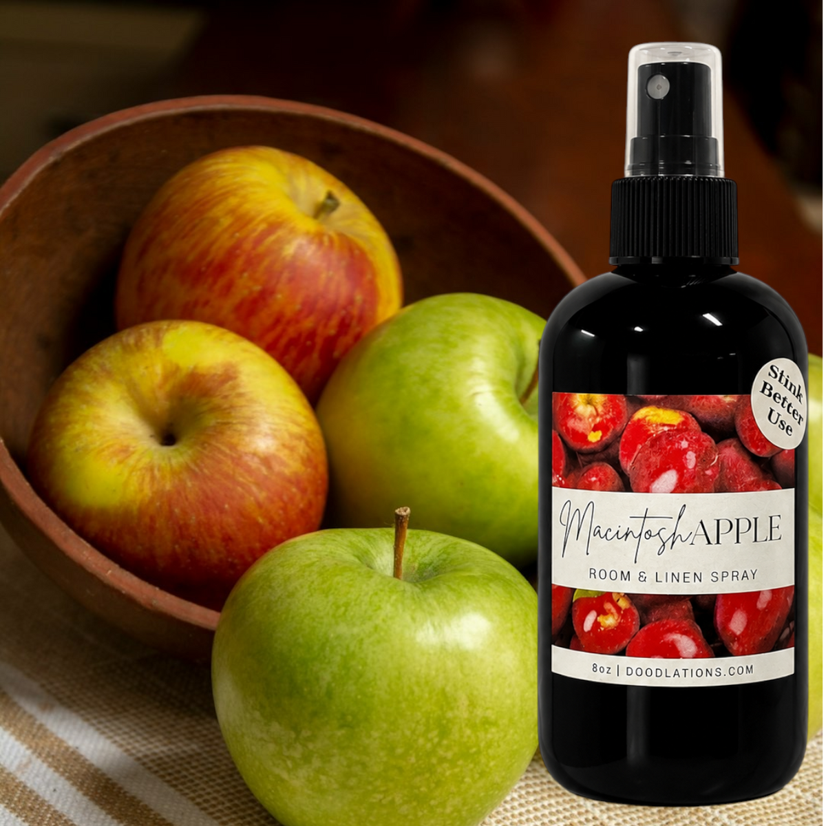 Doodlations Coffee Bar & Boutique Macintosh Apple room and linen spray bottle next to a bowl of fresh apples.