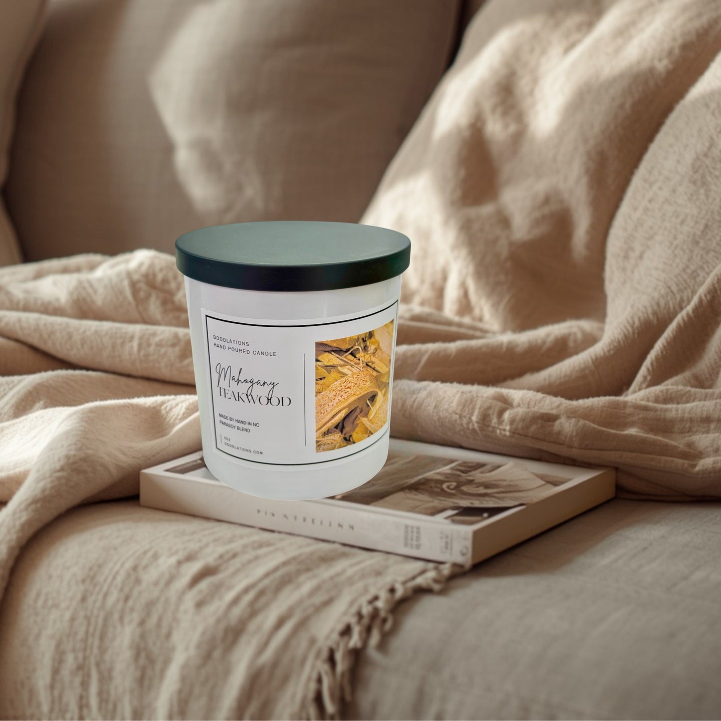 Doodlations Coffee Bar & Boutique Mahogany Teakwood 8oz hand-poured soy blend candle with a black lid.