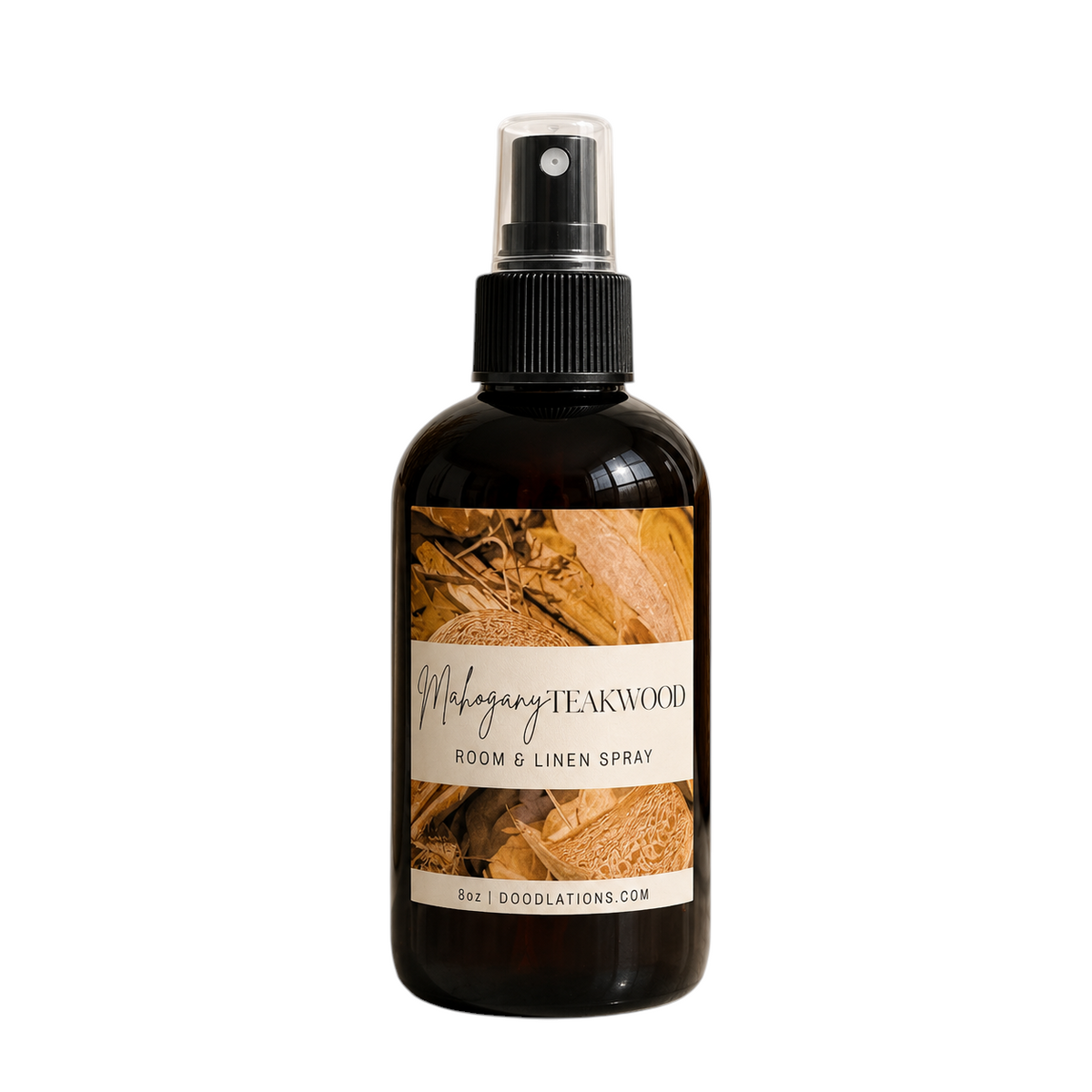 Doodlations Coffee Bar & Boutique Mahogany Teakwood room and linen spray in an amber glass bottle with a black sprayer.