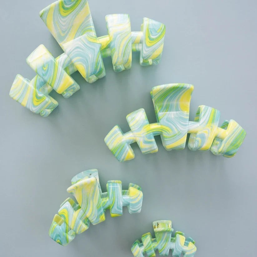 Doodlations Coffee Bar & Boutique Classic By the Sea Shore claw clips in a green, yellow, and blue marble pattern.