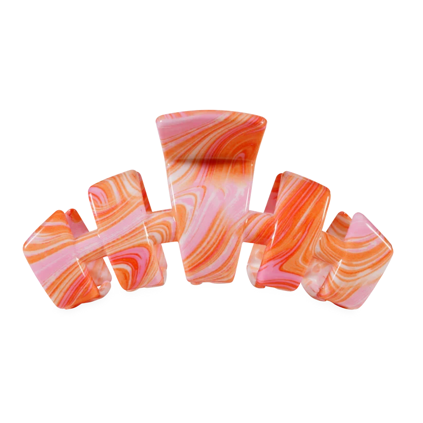 Doodlations Coffee Bar & Boutique Classic Just Keep Swimming claw hair clip with a pink and orange marbled pattern.