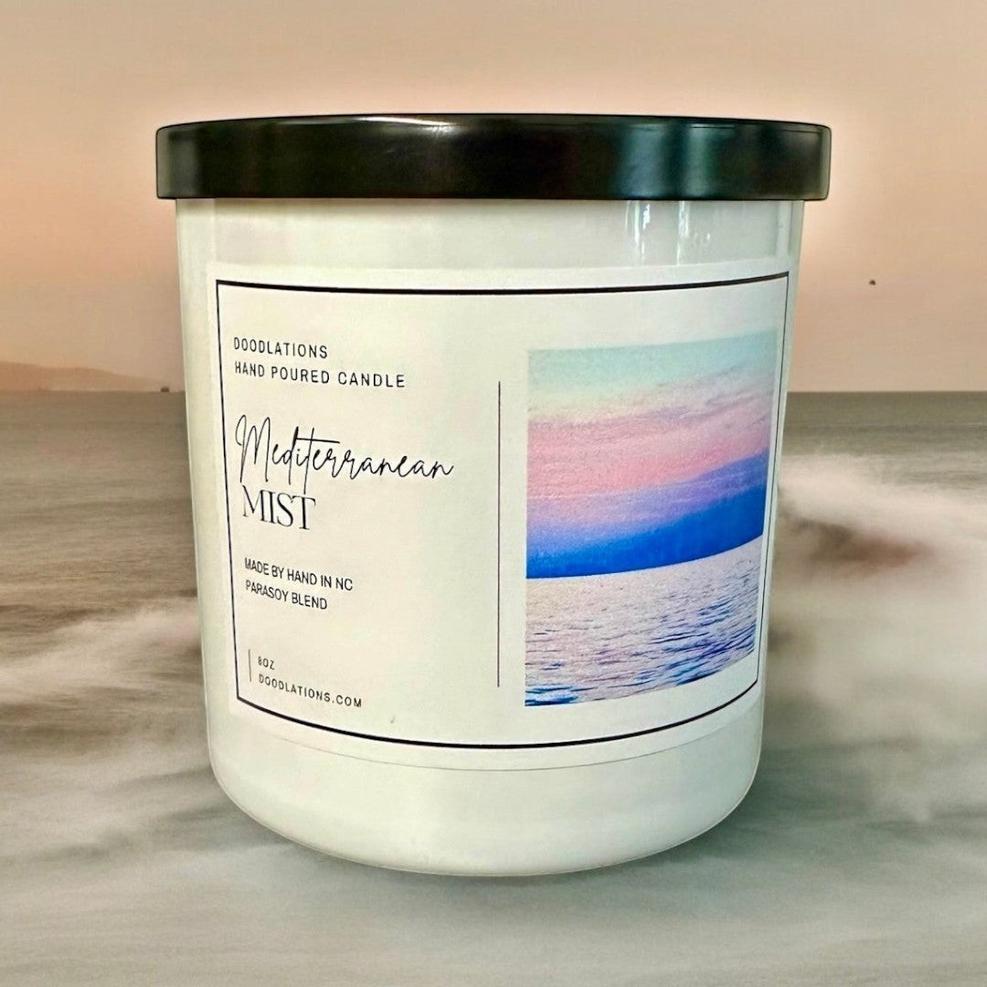 Doodlations Coffee Bar & Boutique Mediterranean Mist hand-poured soy blend candle with a coastal sunset image.