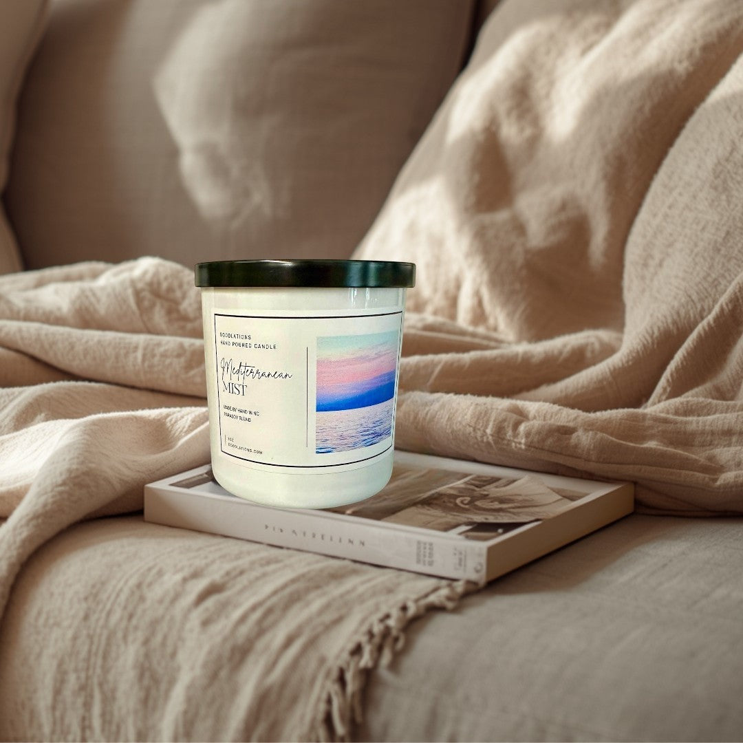 Doodlations Coffee Bar & Boutique Mediterranean Mist hand-poured soy blend candle with a coastal sunset image.