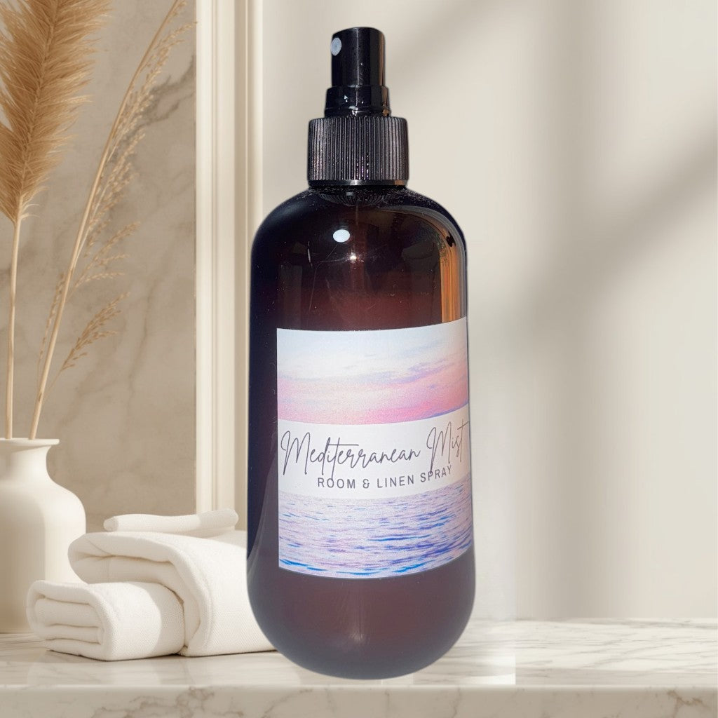 Doodlations Coffee Bar & Boutique Mediterranean Mist room and linen spray in amber glass bottle with a coastal sunset label.
