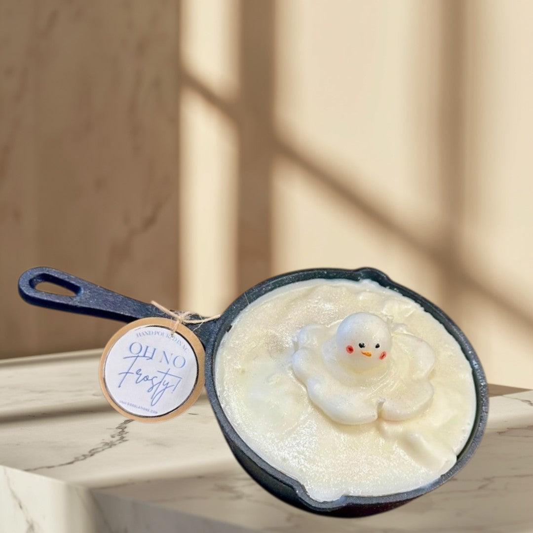 Doodlations Coffee Bar & Boutique Melting Snowman Skillet candle, white wax with a melting snowman figure, holiday decor