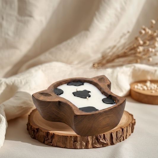 Doodlations Coffee Bar & Boutique mini cow head dough bowl candle with white wax and black cow spots.