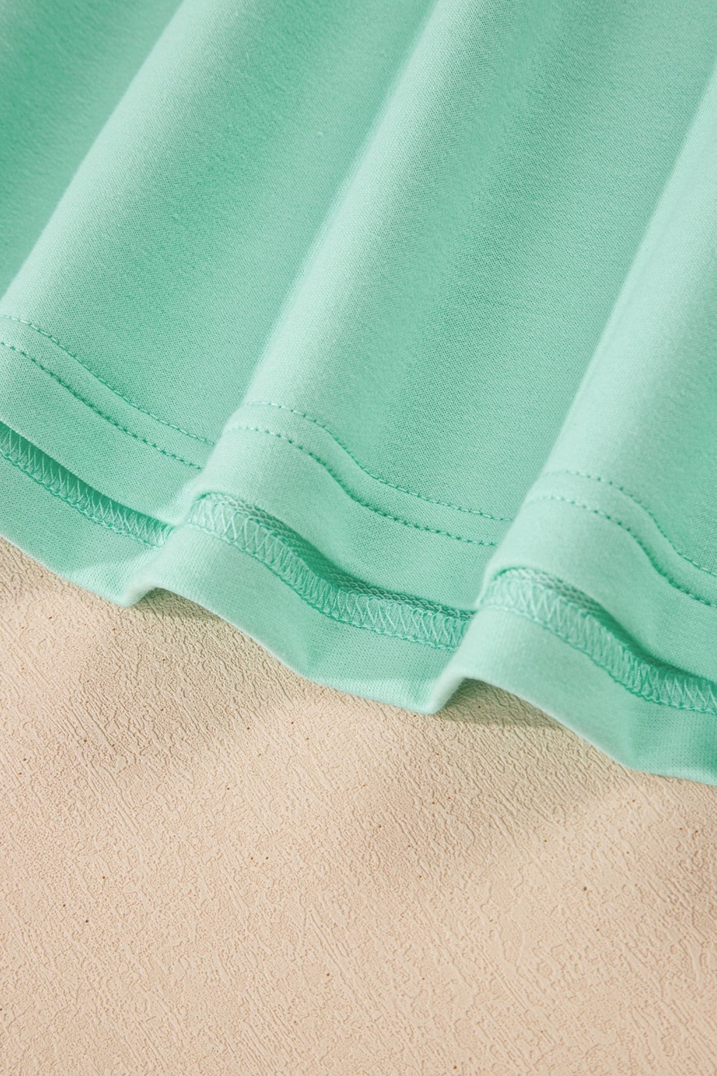 Doodlations Coffee Bar & Boutique mint green two-piece lounge set, soft fabric, V-neck top, drawstring pants, elastic waistband, side pockets.