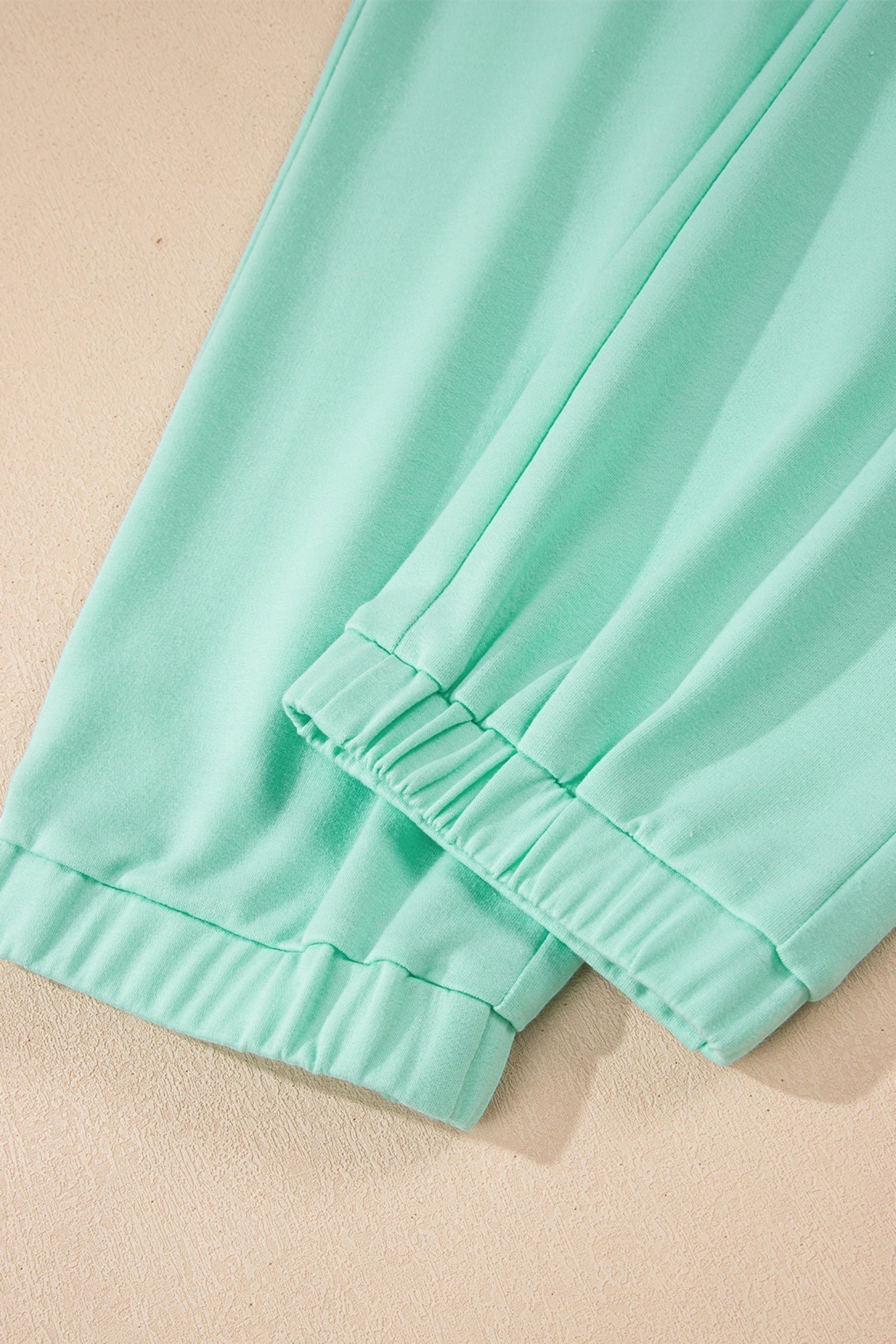 Doodlations Coffee Bar & Boutique mint green two-piece lounge set, soft fabric, elastic waistband, drawstring pants.
