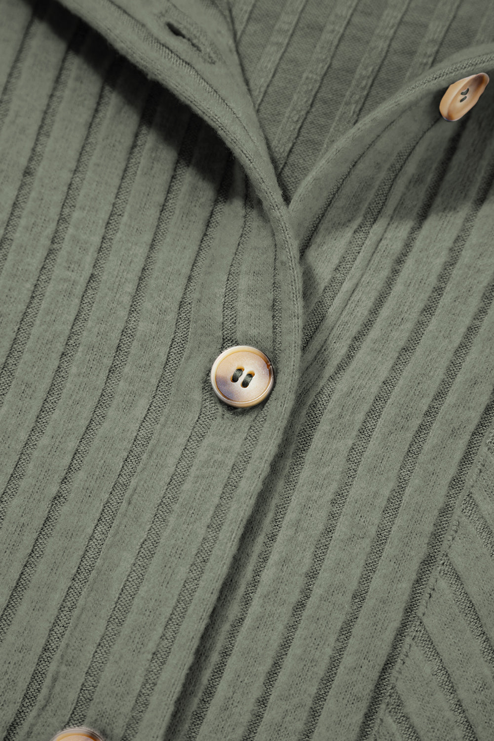 Close-up of a Doodlations Coffee Bar & Boutique mist green ribbed long sleeve button-down shirt with textured fabric.