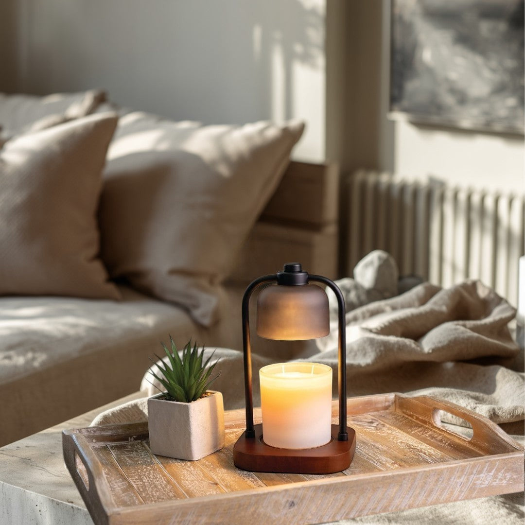 Doodlations Coffee Bar & Boutique modern wood and metal candle warmer lamp with a frosted shade over a lit candle.