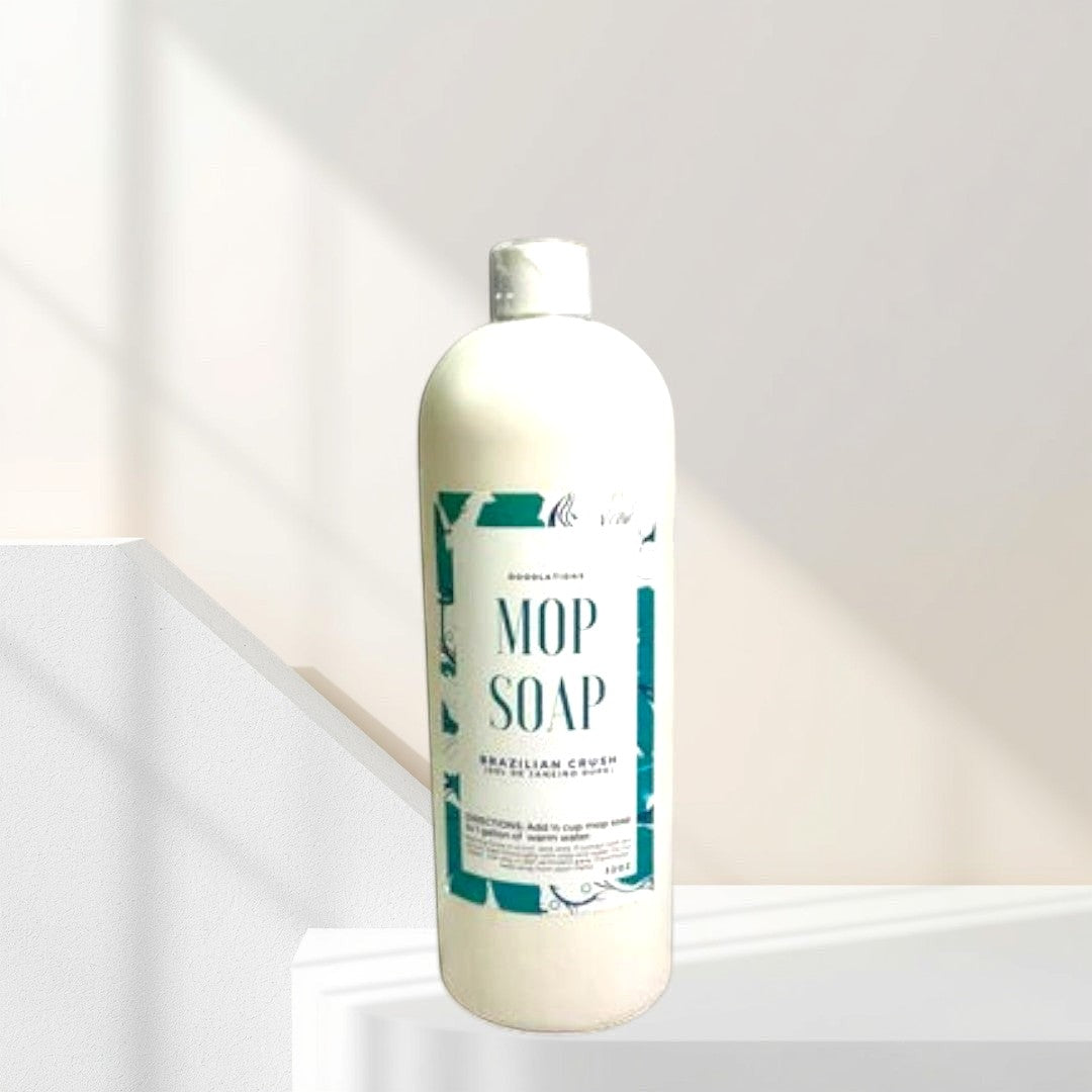 Doodlations Coffee Bar & Boutique Brazilian Crush concentrated mop soap in a white bottle with a teal label.