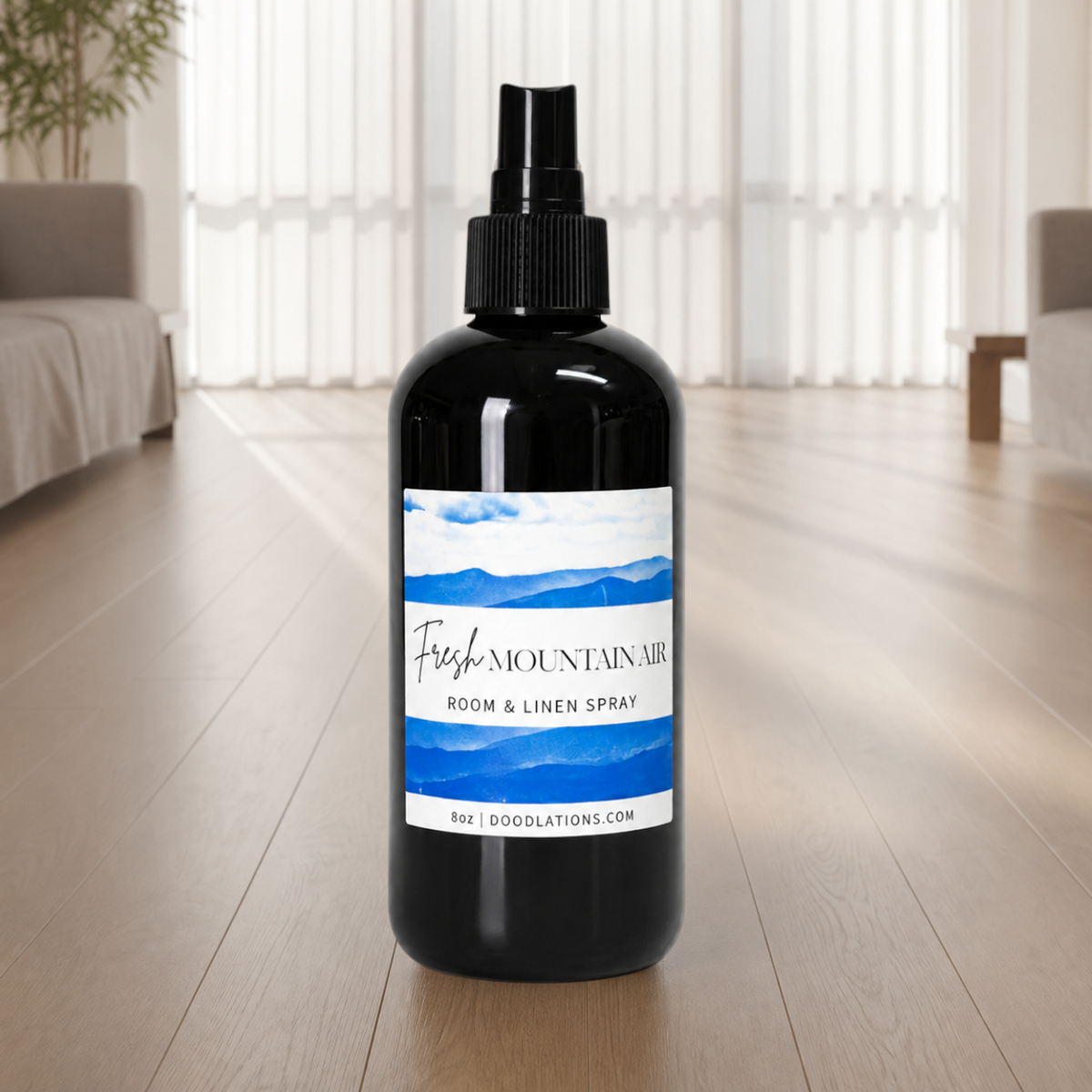 Doodlations Coffee Bar & Boutique Fresh Mountain Air room and linen spray in a black bottle with a blue mountain label