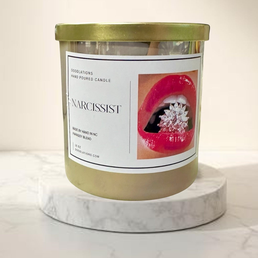 Doodlations Coffee Bar & Boutique Narcissist luxury hand-poured soy blend candle with a bold floral-fruity scent.