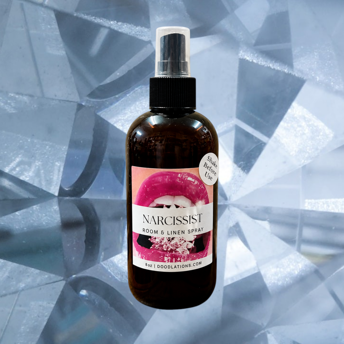 Doodlations Coffee Bar & Boutique Narcissist room and linen spray in an amber bottle with a vibrant lip graphic label