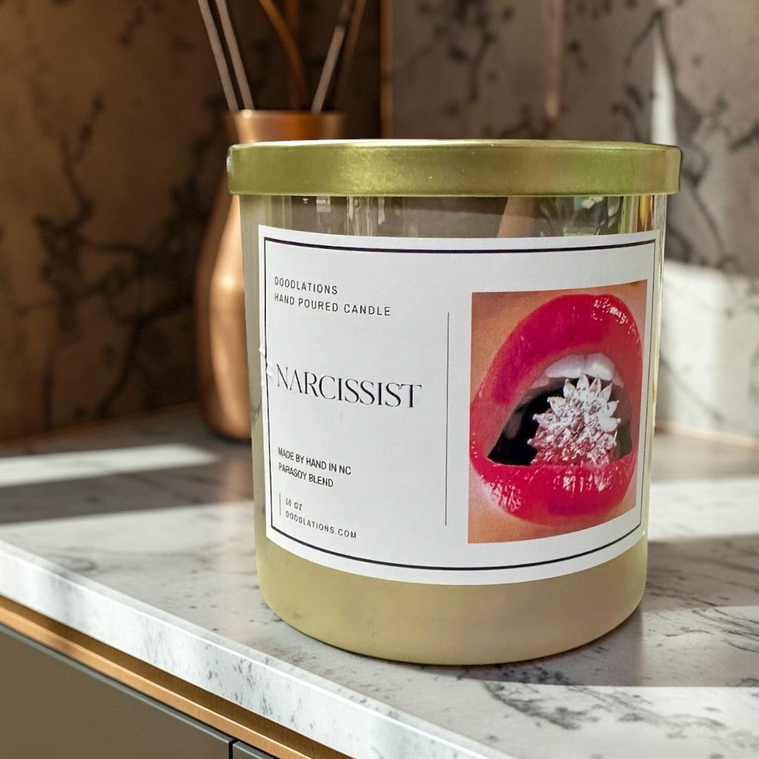 Doodlations Coffee Bar & Boutique Narcissist luxury hand-poured soy blend candle with a bold floral-fruity scent.
