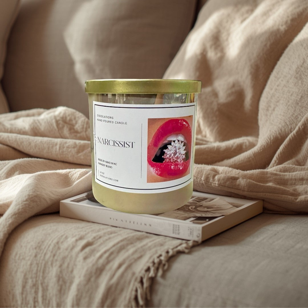 Doodlations Coffee Bar & Boutique Narcissist luxury hand-poured soy blend candle with a bold floral-fruity scent.