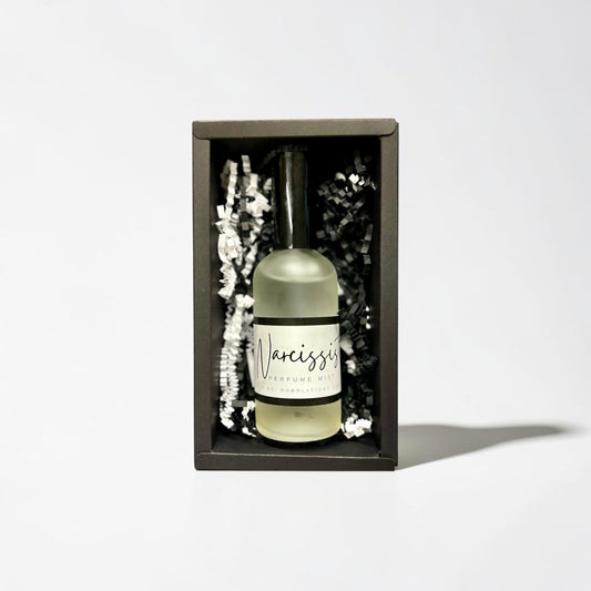Doodlations Coffee Bar & Boutique The Narcissist luxury fine mist perfume in a black gift box with paper filler.